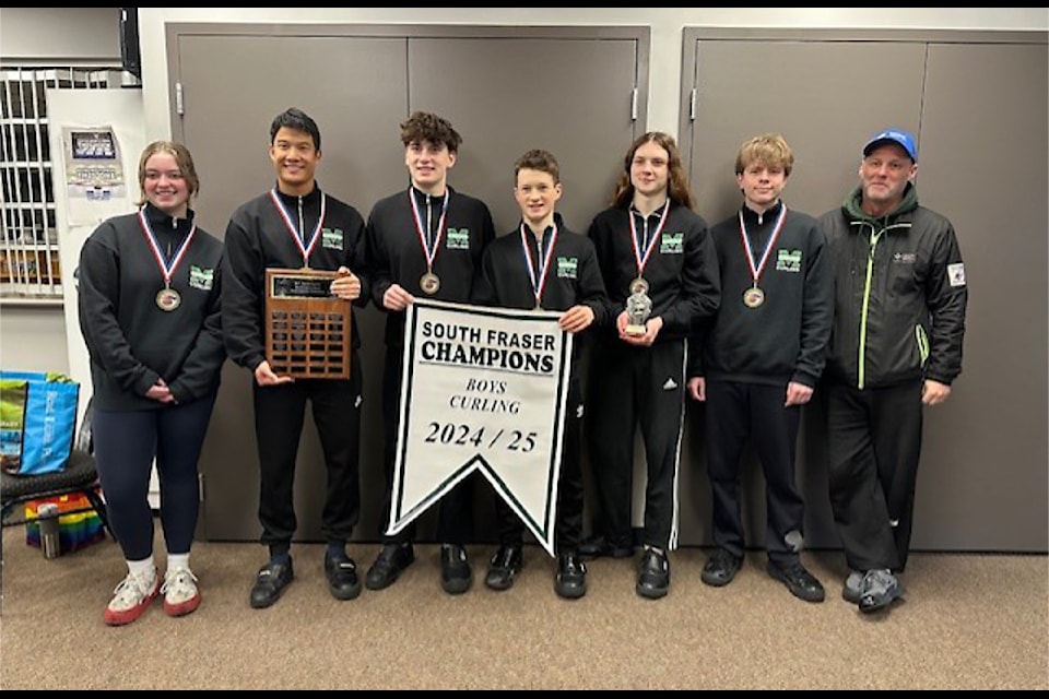 Earl Marriott Secondary School's Kaitlyn Hoffert, left,  Nathan Wayman, Keaton Glassford, Owen Lowe, Sawyer Van Hulsentop, Ruben Deefholts, and coach Ed Holland. They won the South Fraser zone championship Jan. 25.