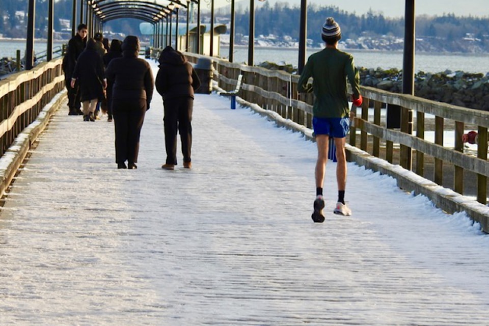 Alfred Anderson captured this photo of a hardy runner on the frozen pier on Tuesday, Feb. 4. "I am glad he kept his head warm," Alfred writes.       