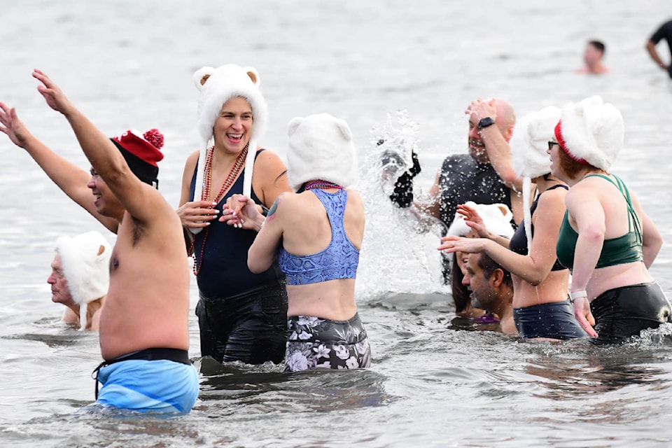 Aptly capped dippers were among participants who braved the chilly waters off White Rock to ring in 2025.