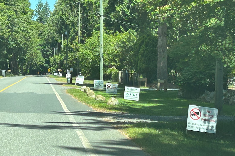Yard signs line a stretch of 196 Street on the South Surrey- border in South Campbell Heights, in protest of temporary-use permits for truck parking projects in the area.