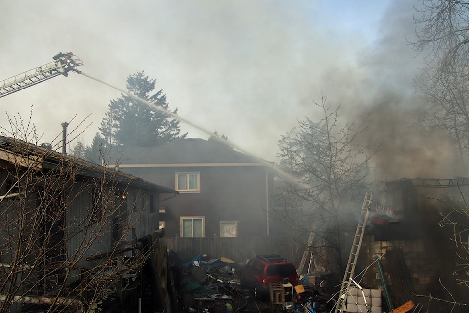 Surrey Fire Service crews battle a structure fire in the 14300-block of 103 Avenue Sunday morning (March 30).