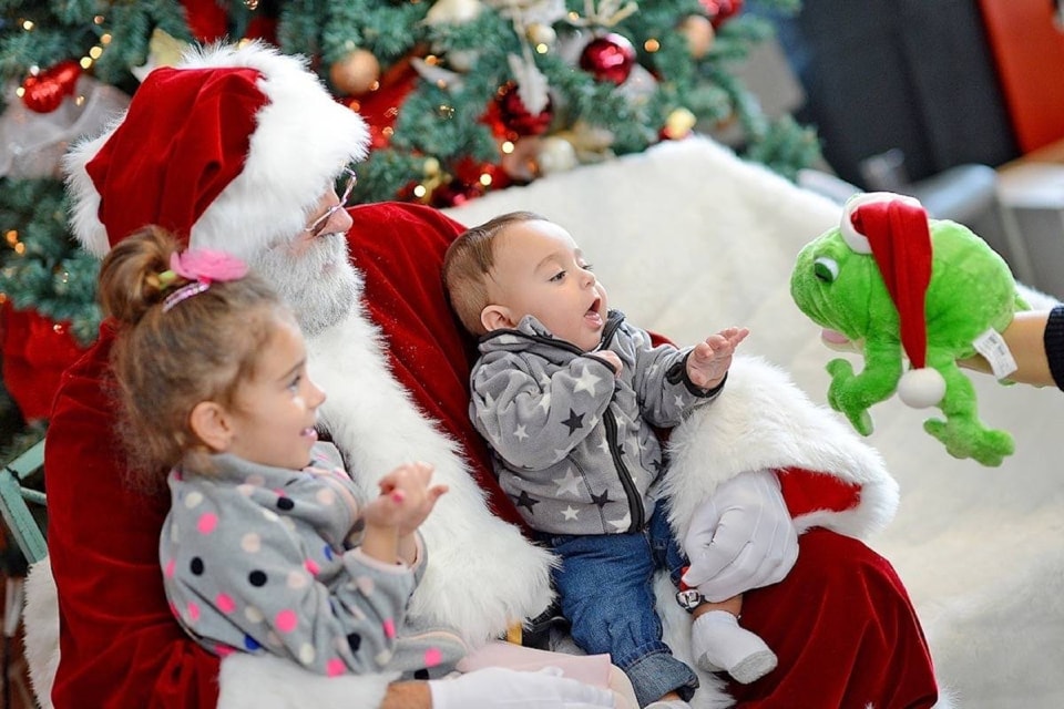Santa (Peter Williams) sits with siblings Hanna (left) and Jude Rancourt at the White Rock Firefighters’ 2016 Breakfast With Santa. 