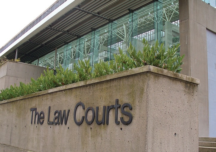 Signs and exterior of the Vancouver Law Courts. - stock photos