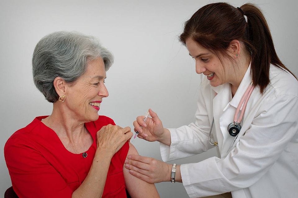 18434917_web1_15813-a-senior-woman-receiving-a-vaccination-shot-from-her-doctor-or