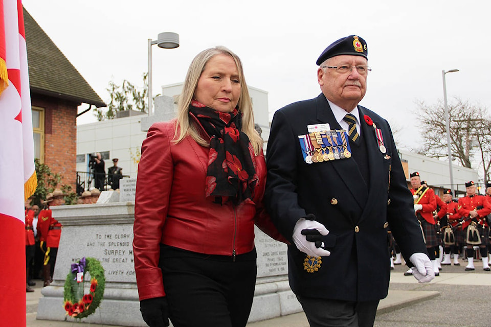 Photo: Malin Jordan Earl Fraser, service officer for the Cloverdale Legion, escorts Silver Cross Mother Sian LeSueur after she laid a wreath at the cenotaph. Her son, Garrett William Chidley, was killed in Afghanistan in 2010. See Page 6 for more pictures.