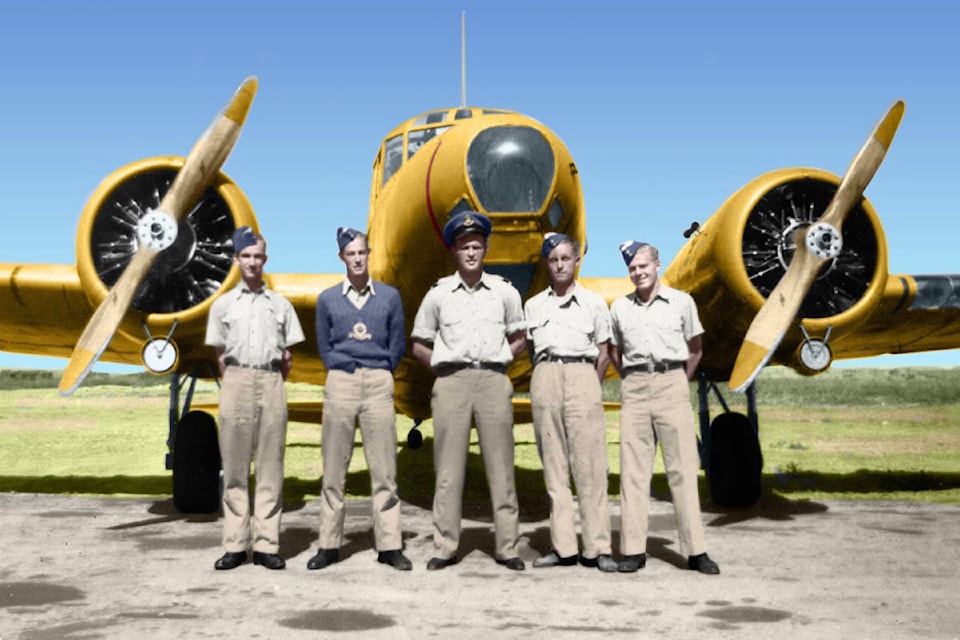Mack Richards, wearing a blue RCAF sweater, stands with his instructors in front of an Anson aircraft in the spring of 1944. (Contributed photo)