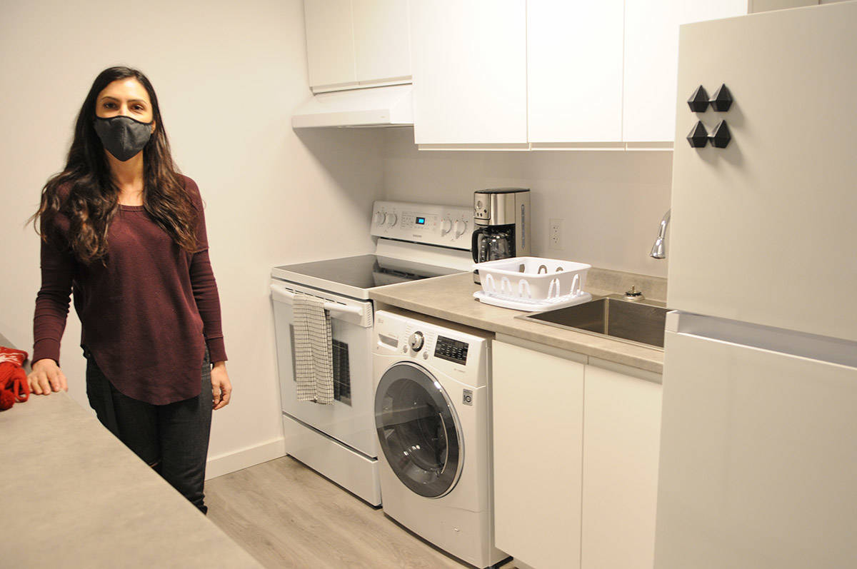 Paige Van Klei is seen in the kitchen of one of the two-bedroom units at The Switchback, a supportive housing building for youth on Dec. 18, 2020. (Jenna Hauck/ Chilliwack Progress)