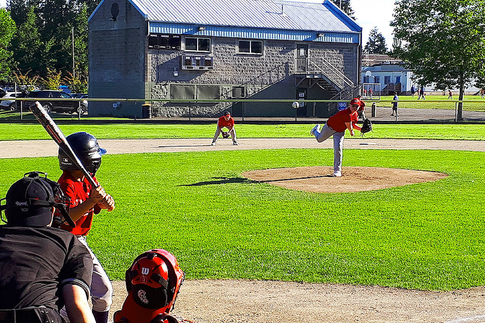 A pitcher for the Cloverdale Reds hurls a ball toward a Phillies’ batter in a Mosquito (U11) division game at Cloverdale Ball Park June 8. Since game play was reinstated May 25, volunteers have been working around the clock and kids have been playing games seven days a week. (Photo submitted by John Braaten)