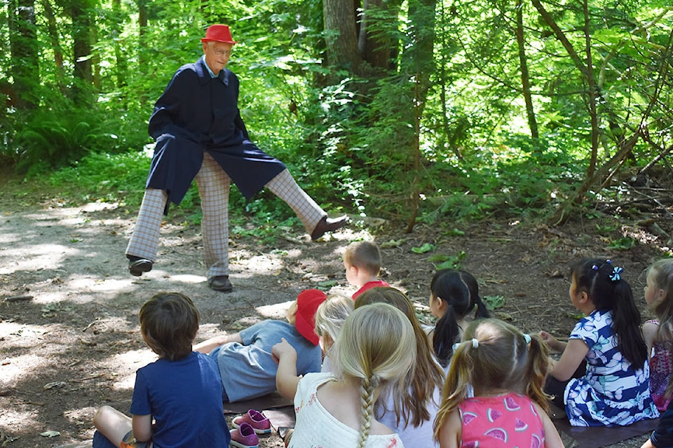 Retired doctor Don Stewart - who has become a ‘grandfriend’ to Ellen Petersson’s kindergarten/Grade 1 students at Ray Shepherd Elementary - entertain the children during one of their recent forest walks with one of his ‘party pieces,’ a droll three-legged dance performed to ‘Can I Have This Dance For The Rest Of My Life?’. (Alex Browne photo)