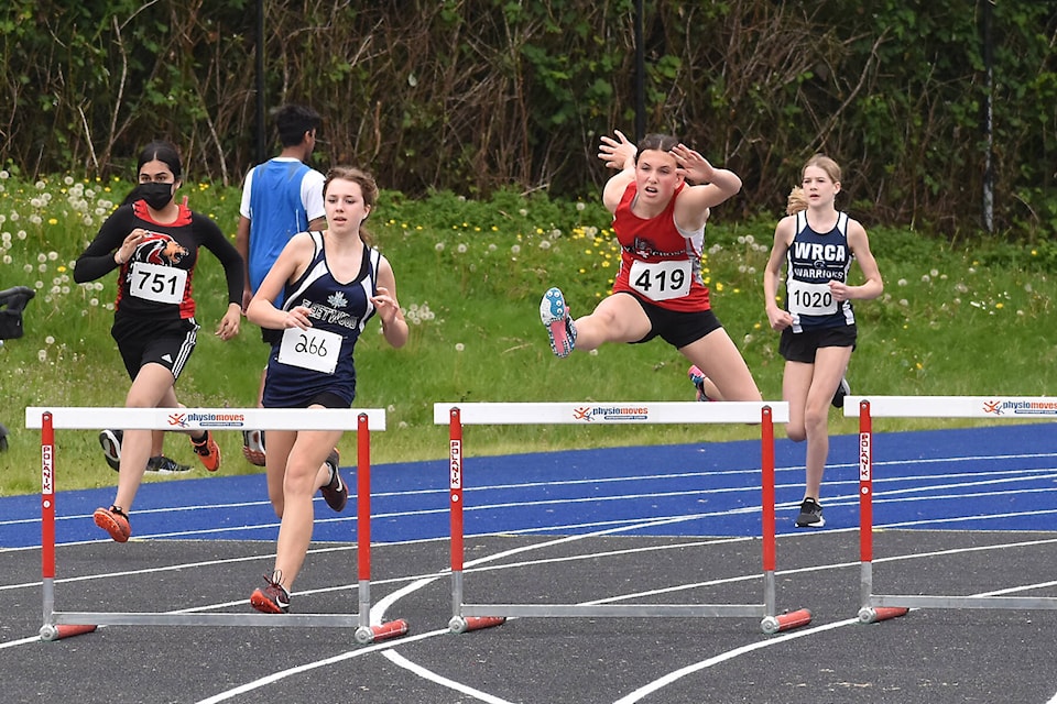 With competitors chasing, Holy Cross Regional School’s Cora Clendenin leaps over a hurdle during the Grade 8 girls 200-m hurdles during South Fraser Track and Field Championships. (Nick Greenizan photo)