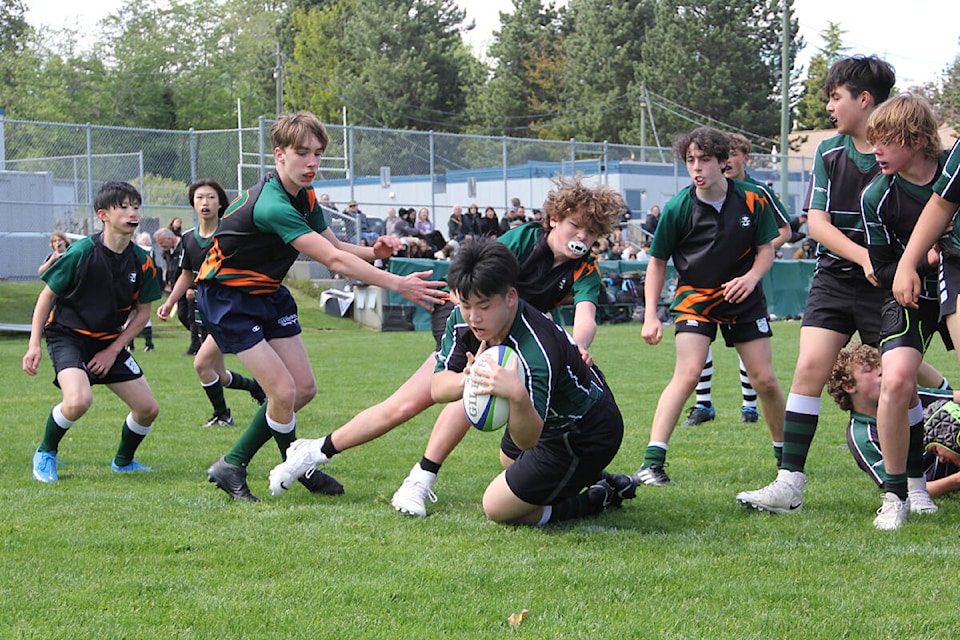 Aiden Choi scores a try for Lord Tweedsmuir after running through several Earl Marriott defenders in the Surrey Grade 8 boys rugby championship game in May. Tweedy ultimately lost the game. (Photo: Malin Jordan)