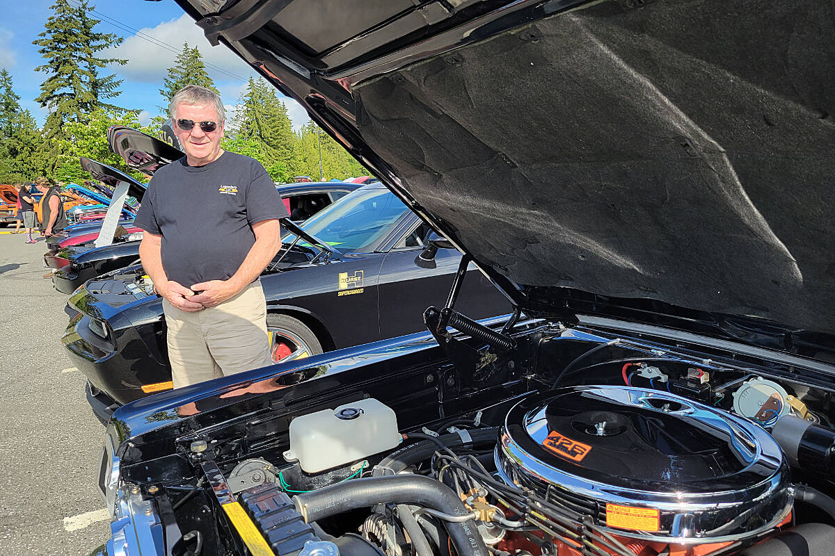 Aldergroves John Ross stands between his two trophy-winning cars at the 29th edition of the Mopar Madness car show in Langley on Sunday, July 10. Mopars Unlimited Car Club president Garry Keay announced they have raised $10,000 for Ukraine humanitarian relief. (Dan Ferguson/Langley Advance Times)