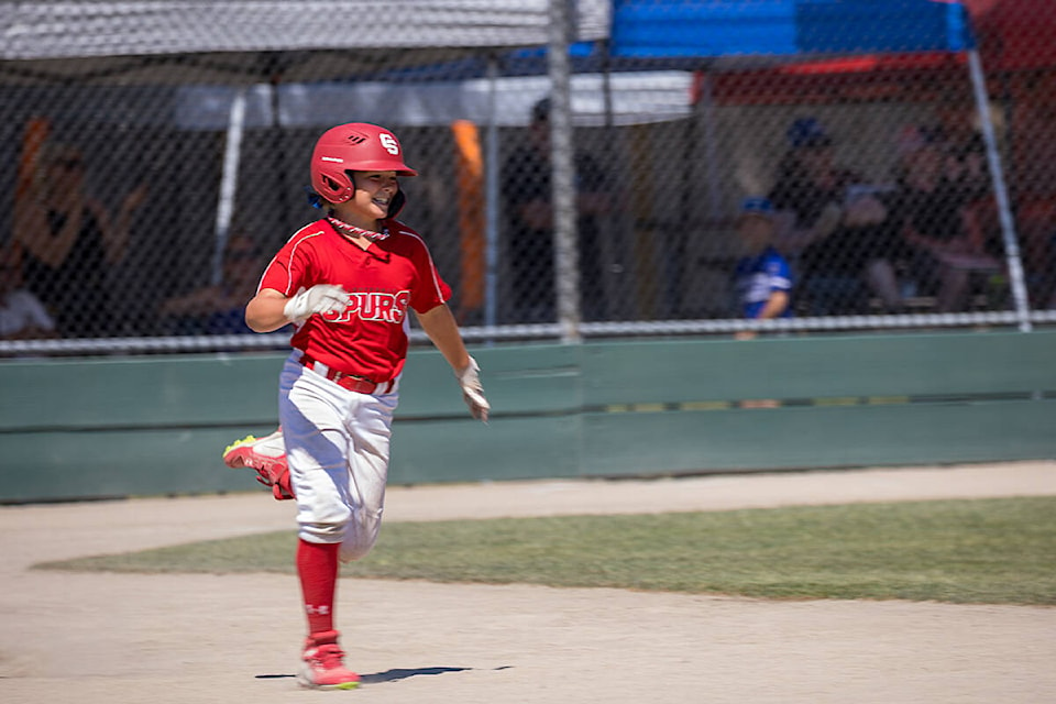 Maddox MacDonald smiles as he rounds first after cranking a home run against North Langley July 30 in a U11 AAA Tier 2 provincial championship tournament game. (Photo: Jason Sveinson)