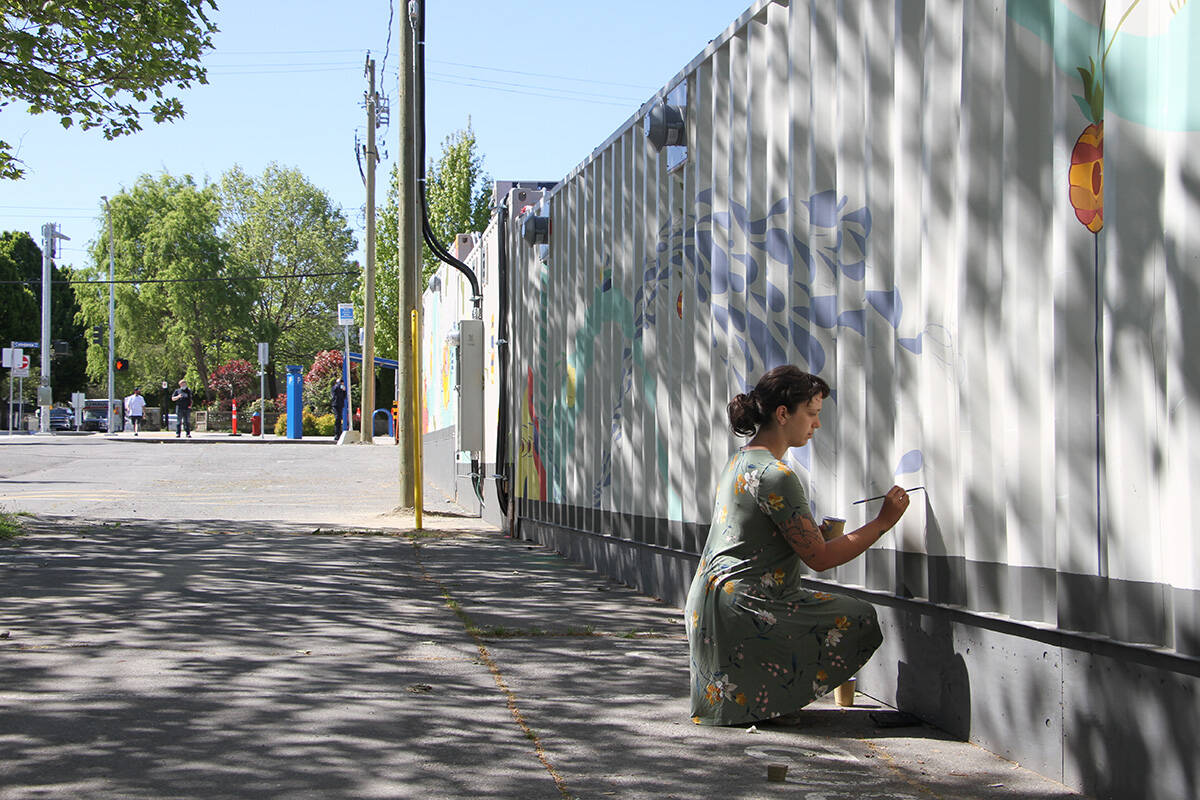 Local graphic artist Kay Gallivan painted the side of Our Place Societys Tiny Home Village on the day of its opening in North Park, May 14. (Black Press Media file photo)