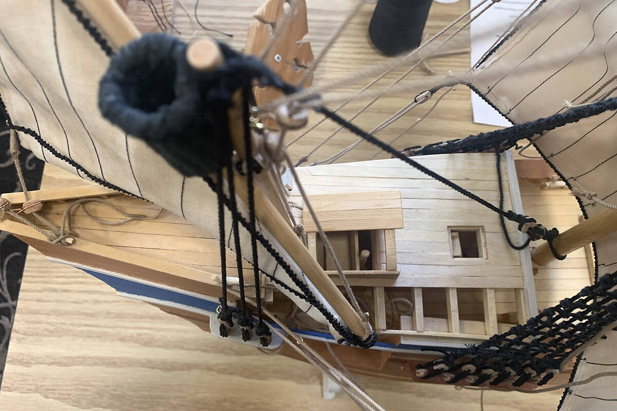 Kosters version of Willem Barents ship from 1585 has an unfinished feel to it, which is intentional. By looking directly down into the boat, the different layers and details can be seen. A stick is one of the pieces that can be seen, which was the original wheel of ships that was used before the traditional wheel we know now was invented. The stick, however, did not sail that well on its own. The black-yarn covered cylinder was made from a wine bottle cork that Koster filed into shape and wrapped in the thread. This piece would hold a look-out person who could shout to the person steering the ship and guide them. The holder allowed for the two to be close enough together, as an intercom system was not yet invented during that era. (Sobia Moman photo)