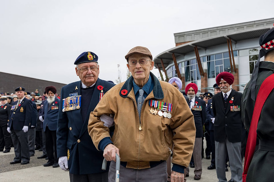 Dick Deck, World War II airman and former POW, is accompanied by Earle Fraser from the Cloverdale Legion to the cenotaph in Veterans’ Square Nov. 11, 2022. Deck laid a wreath on behalf of all prisoners of war. (Photo: Jason Sveinson)