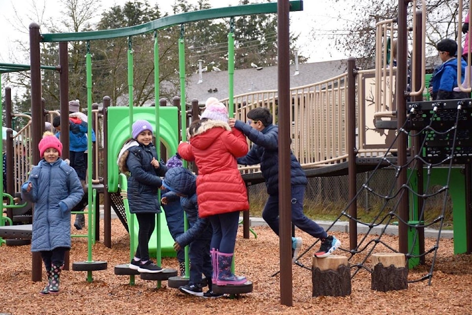 Students play on Jarvis Traditional Elementary’s new accessible playground, which officially opened on Friday, Jan. 13, 2023. (James Smith photo)