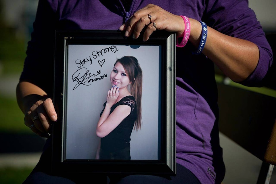Carol Todd holds a photograph of her late daughter Amanda Todd signed by U.S. singer Demi Lovato with the words ‘Stay Strong.’ (THE CANADIAN PRESS/Darryl Dyck)