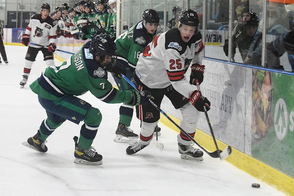Alberni Valley Bulldogs forward Will Elger battles along the boards with Ross Roloson and Aaron Schwartz of the Surrey Eagles during Game 3 of the BCHL’s Coastal Conference Semifinals at the Alberni Valley Multiplex on Tuesday, April 18. (ELENA RARDON / Alberni Valley News)