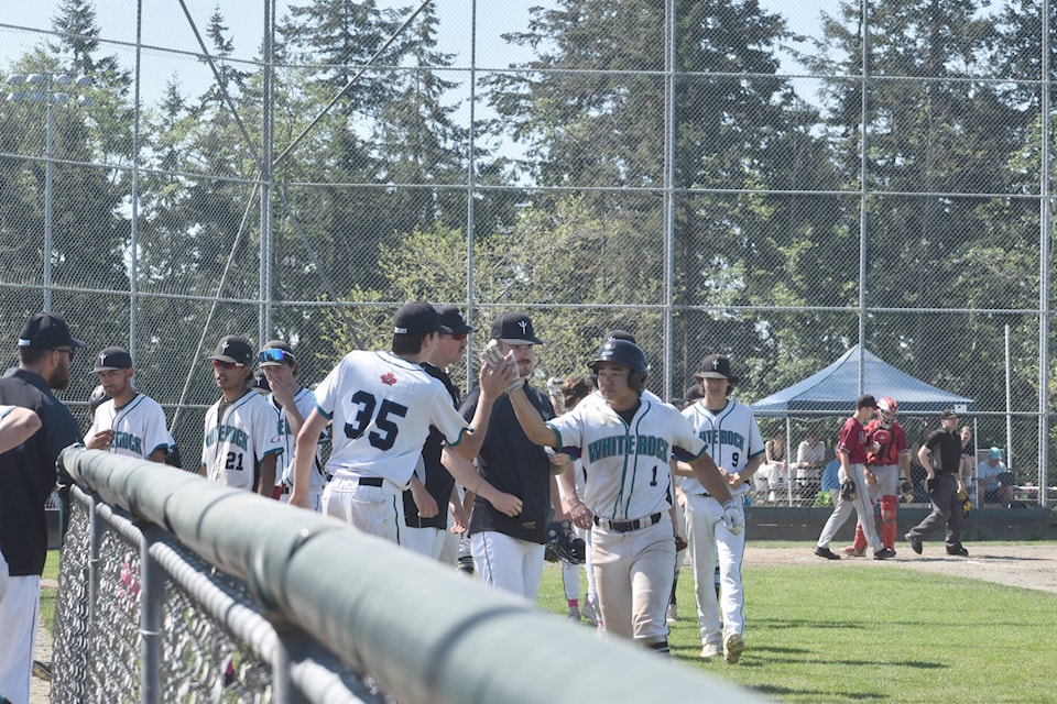 White Rock Senior U18 Tritons’ Kai Okuyama celebrates with his team after getting a run in Game One of a double header against the Senior Victoria Eagles at South Surrey Athletic Park on Sunday. They won the second game 13-3 in six innings. The team is currently in second place in the BC Premier Baseball League standings. (Tricia Weel photo)