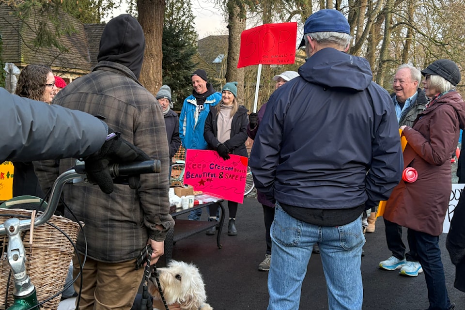 Nearly 50 protesters gathered at the planned construction site on Alexandra Street along Crescent Beach on Monday, March 10 with posters to halt planned construction of a pedestrian walkway.