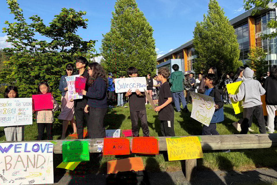 Students, parents and supporters gathered ahead of the regular May 14 school board meeting to protest the district's decision to cut Grade 7 band class.