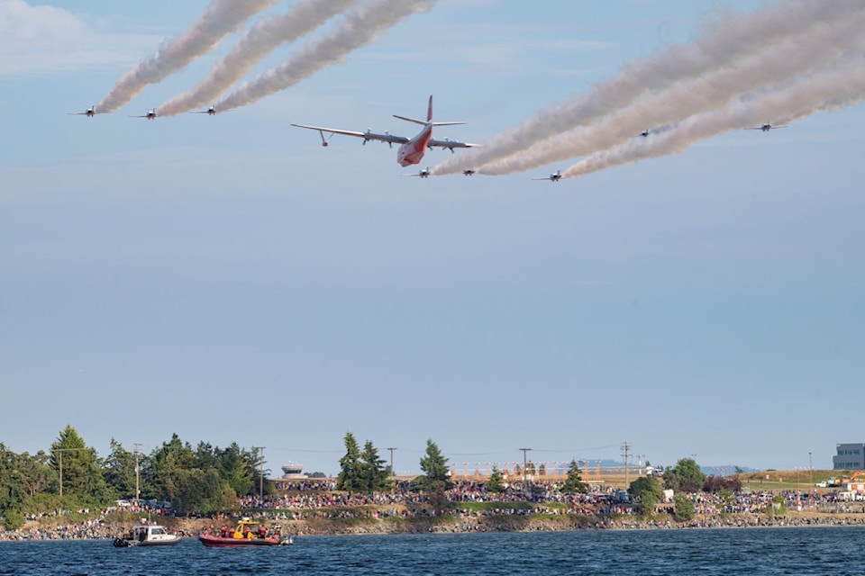 The Hawaii Mars flies in formation with the Canadian Forces Snowbirds air demonstration team over the Saanich Inlet on Sunday, Aug. 11. 