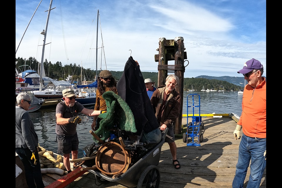 Volunteers gather to help remove trash from Brentwood Bay.