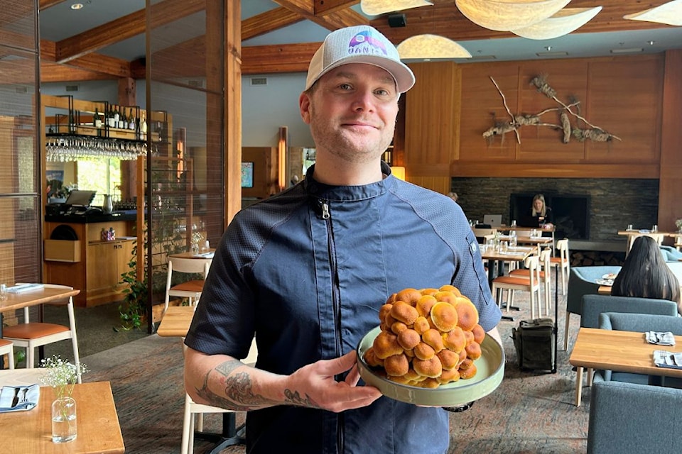 Brentwood Bay Resort's new executive chef Aaron Turner holds up a plate of mushrooms from West Coast Mycology. Turner loves working with ingredients from the Island.