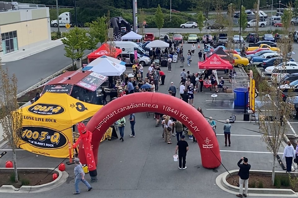 A big crowd fills up Canadian Tire North Saanich garden centre parking lot during the store's grand re-opening.
