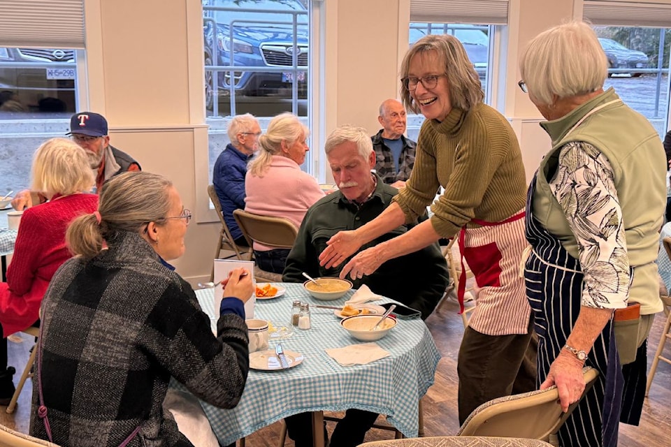 Sandy Parker chatting with community members during the first free lunch event on Feb. 15.