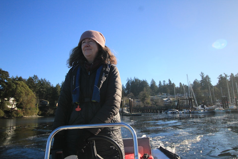 Janis Carmena pilots her dinghy through Brentwood Bay.