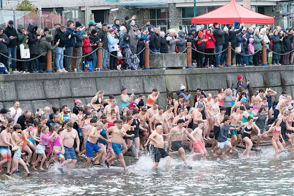 Swimmers rush into the water at the annual Polar Bear Swim in Sidney on New Year's Day.