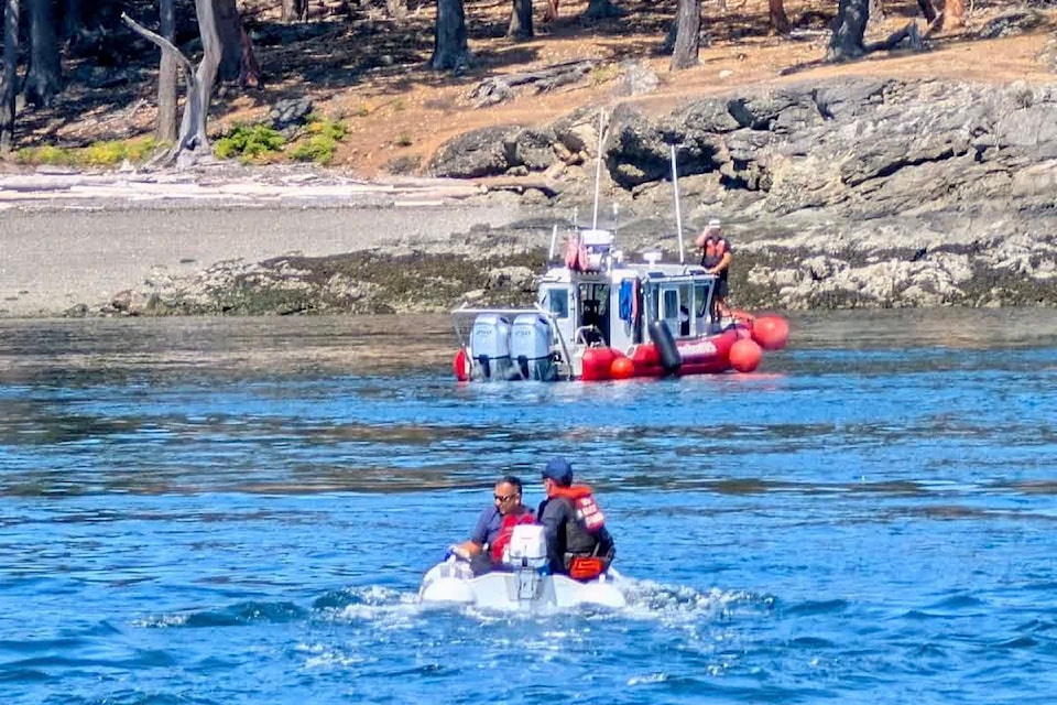 The U.S. Coast Guard uses a sailboat's own dinghy to rescue 10 people near Stuart Island, Wash. on Sunday, July 27. 