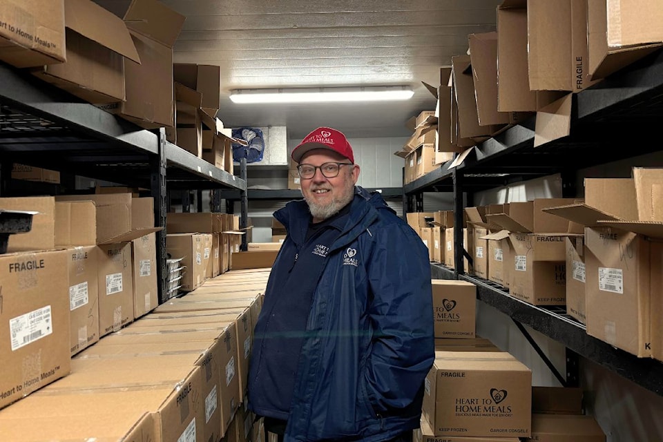 Scott Downton stands in the stocked Heart to Home Meals freezer.