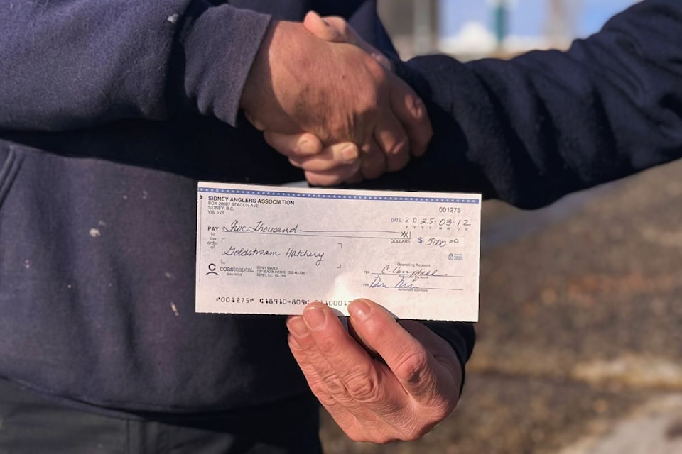 A cheque donation from Sidney Anglers Association to Goldstream Fish Hatchery.