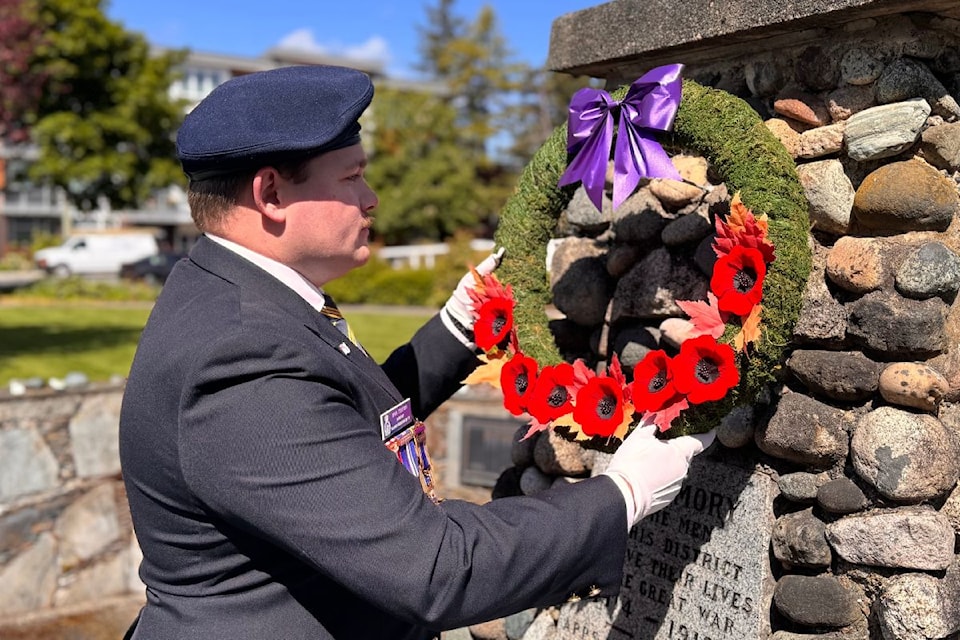 Legion #37 president Ryan Trelford hangs a fresh wreath at the cenotaph in Sidney, May 8.