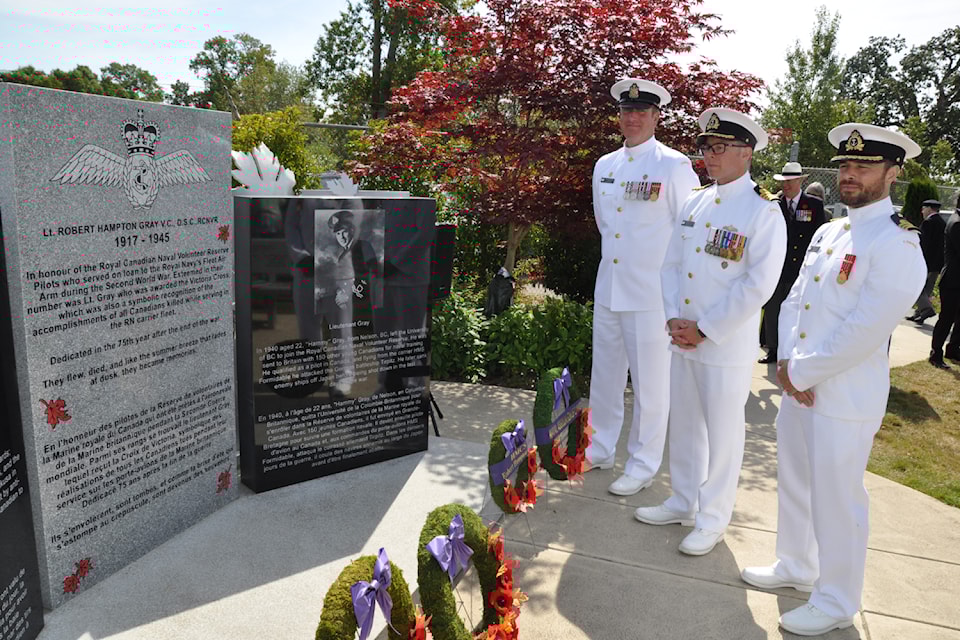 Officers representing Maritime Forces Pacific Headquarters Chief Petty Officer 1st Class Armand Reelick (left), Commander Canadian Fleet Pacific Captain(N) Sam Patchel and Commander Malcolm Girard-Leblanc read the inscriptions on the Robert Hampton Gray Memorial at the BC Aviation Museum at Victoria International Airport. 