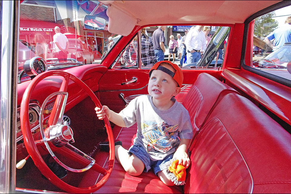 Two-year-old Jaxson Howells of Victoria does his best to keep the interior of a classic car clean during the 2017 Coast Capital Auto Extravaganza in Sidney, hosted by the Torque Maasters Car Club. (Steven Heywood/News staff)
