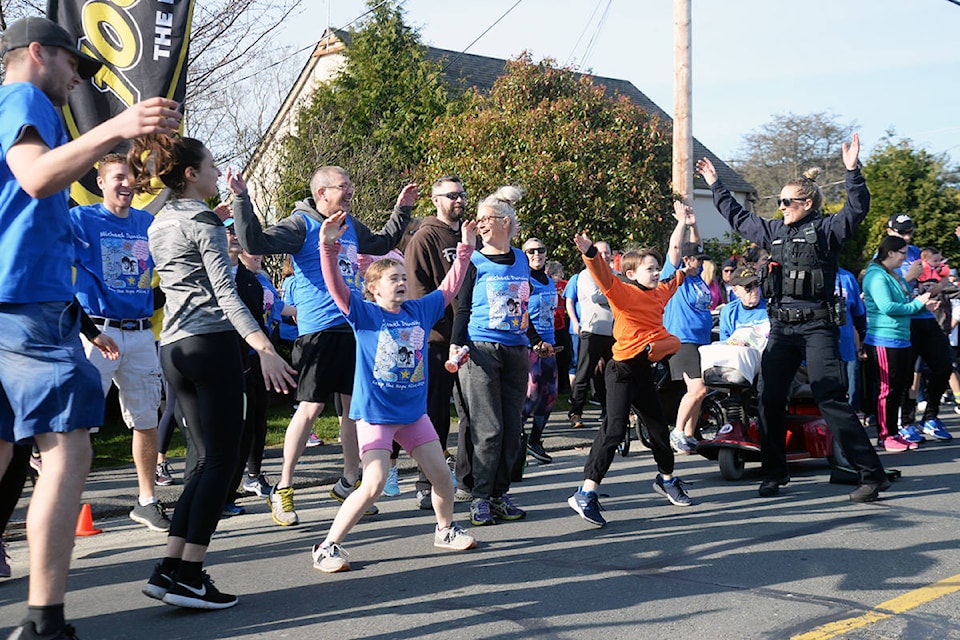 A Victoria police officer warms up with some young runners for the annual Michael Dunahee Keep the Hope Alive Run on Sunday. (Nina Grossman/News Staff) A Victoria police officer warms up with some young runners for the annual Michael Dunahee Keep the Hope Alive Run on Sunday. (Nina Grossman/News Staff)