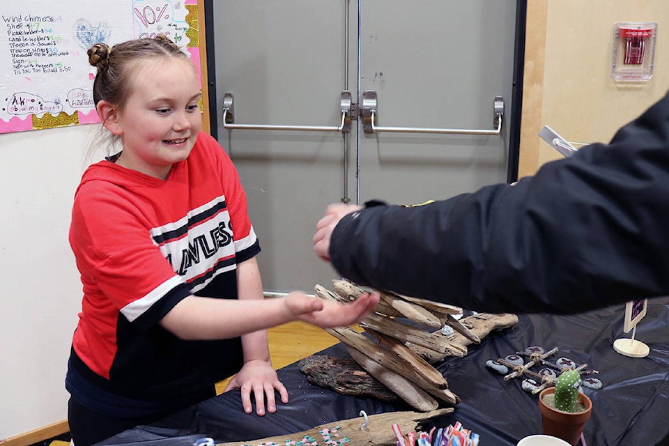 Brooke McClain’s driftwood art included birds, chimes and wall hangings. She was one of many Grade 5 students who took part in the school’s Young Entrepreneurs Fair April 11. (Nina Grossman/News Staff)