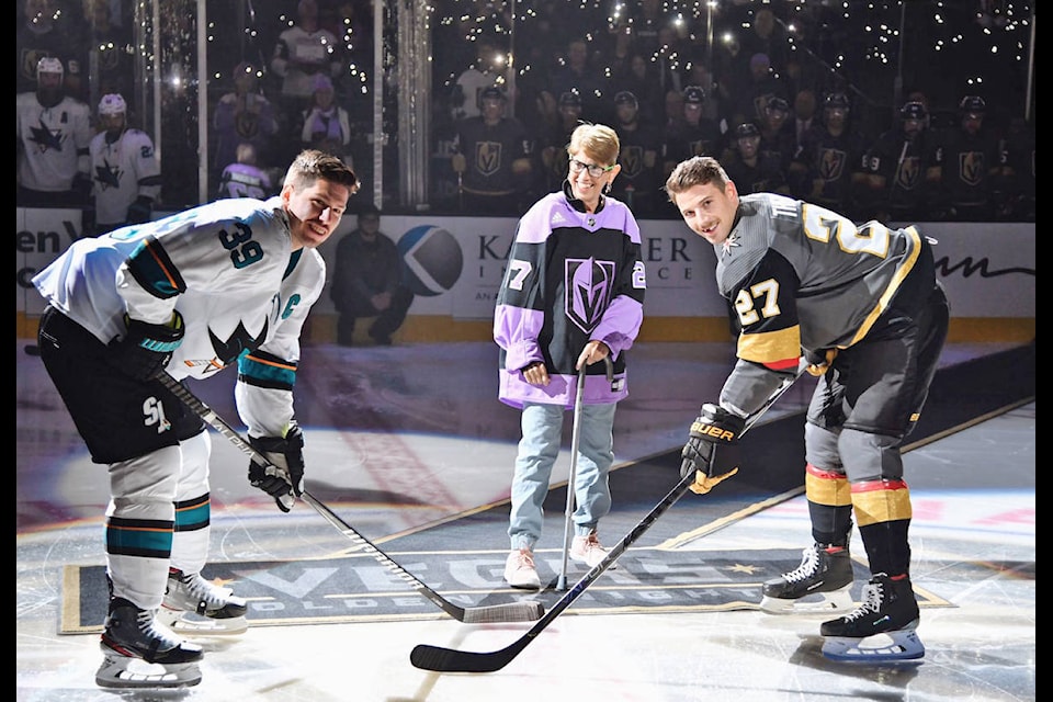 Theodore escorted Darlington out onto center ice in a purple jersey. She dropped the puck amidst a sea of cell phone lights and a roar of arena applause. (Golden Knights photo)