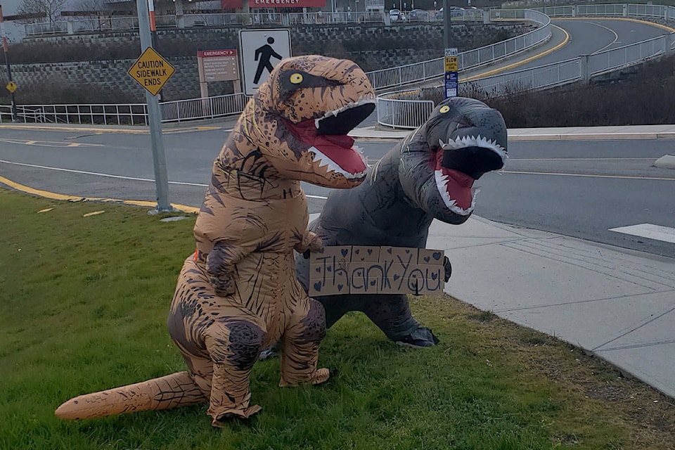 The daughters of Kim Johnson, a Maternity and Pediatrics administrative assistant at Victoria General Hosptial, dressed in T-rex costumes and surprised workers at shift change on April 1. (Island Health/Flickr)