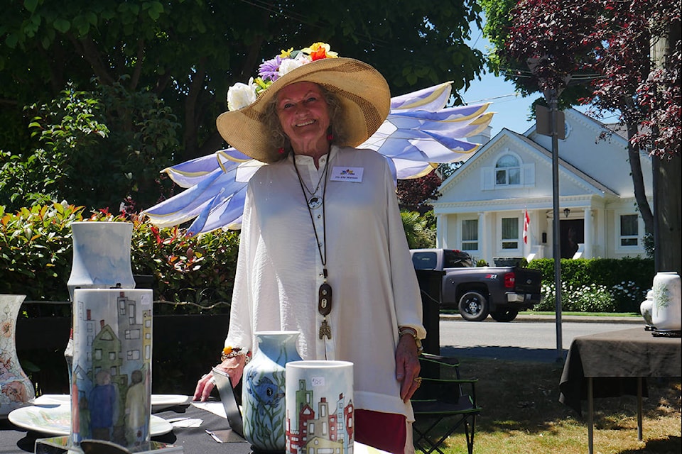 Artist Flo-Elle Watson displaying her painted white porcelain and flower hat at Sunday’s art show and sale on St. Ann St. (Evert Lindquist/News Staff)