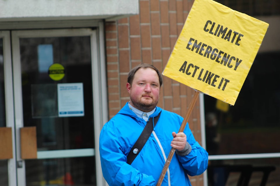 Rally organizer D’Arcy Briggs calls on the federal government to implement the Just Transition Act – legislation aimed at shifting economic priorities. (Megan Atkins-Baker/News Staff)