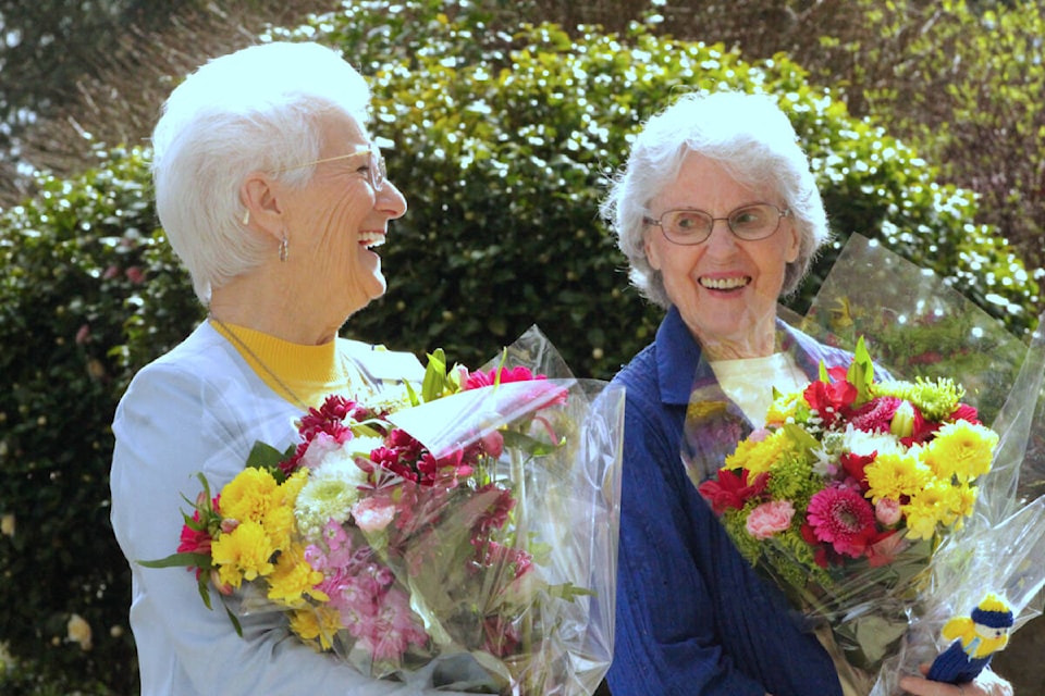 Tini Hayden (left) and Berte Fraser, residents at Berwick Royal Oak, graciously accept flowers for their efforts in raising money for Ukraine. (Megan Atkins-Baker/News Staff)