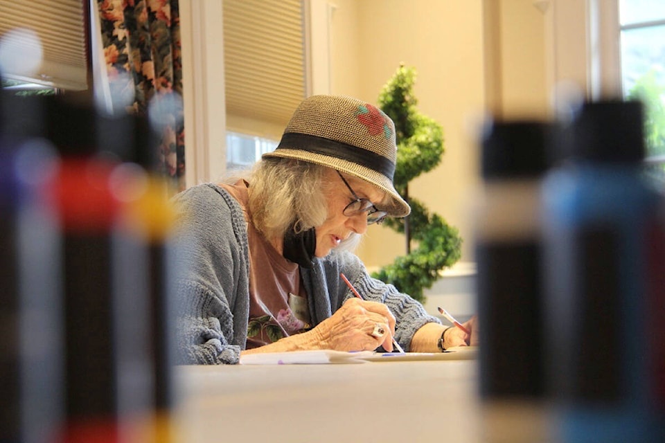Grace Bartha works on her mandala at Carlton House in Oak Bay. (Christine van Reeuwyk/News Staff)