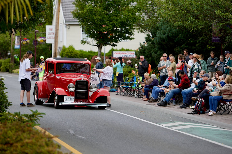 Crowds line Goldstream Avenue in Langford as more than 500 hot rods roll by Saturday as part of Northwest Deuce Days activities ahead of the main show Sunday in downtown Victoria. (Justin Samanski-Langille/News Staff)
