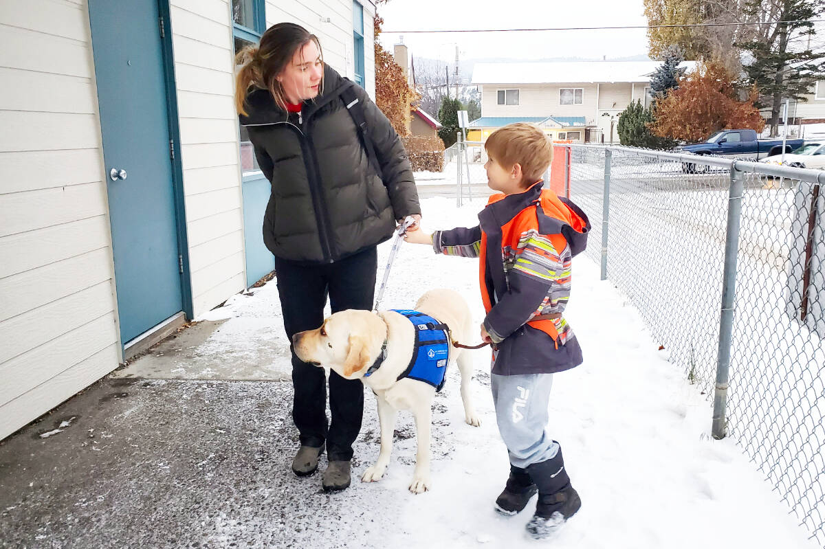 Crystal Taratus, left, with her son Liam and their service dog Sam leave Skyline School where Liam attends the Boys and Girls Club afterschool program. (Monica Lamb-Yorski photo - Williams Lake Tribune)