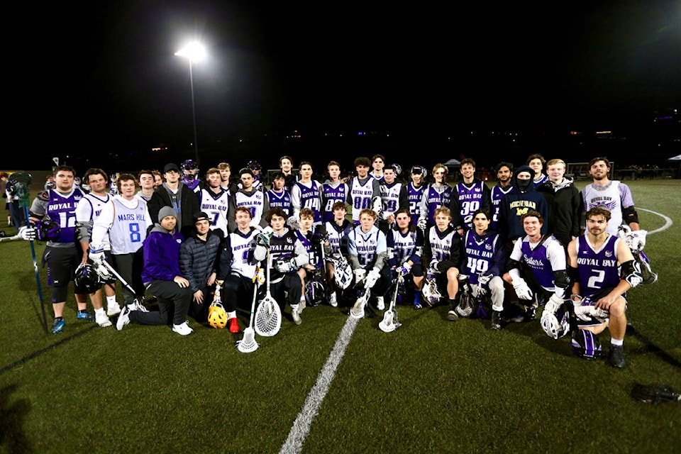 Alumni of Royal Bay Secondary School’s lacrosse academy gather for a group photo after a friendly white versus purple scrimmage Wednesday (Dec. 14) during the program’s first-ever alumni event. (Justin Samanski-Langille/News Staff)